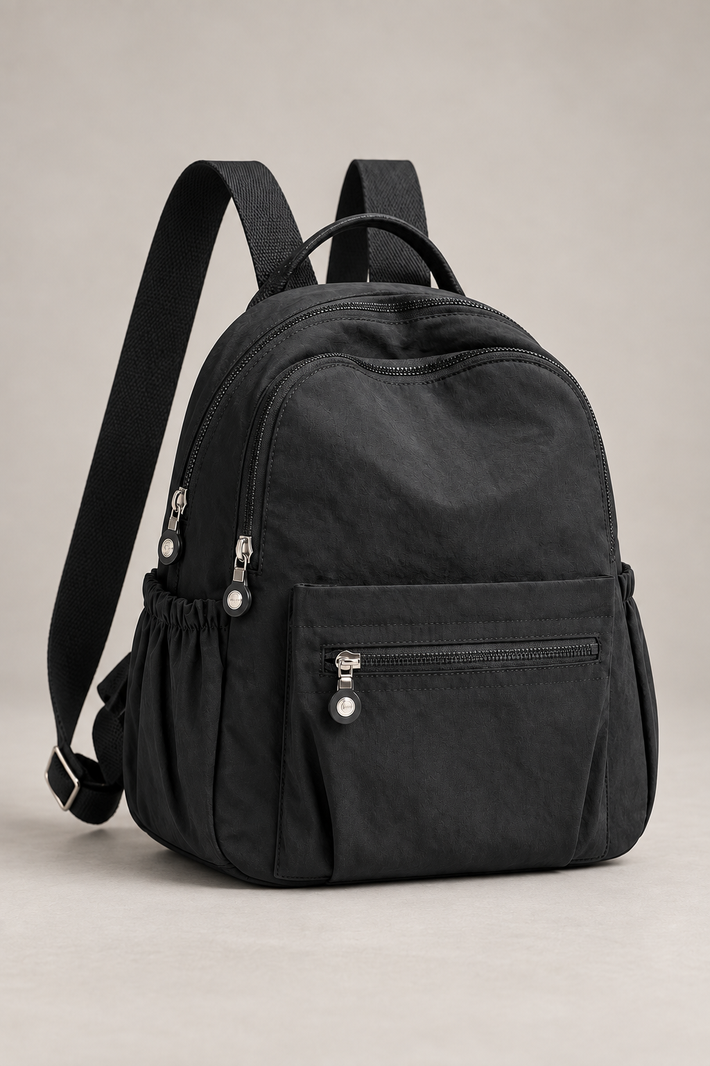 Women’s black compact nylon travel backpack studio view