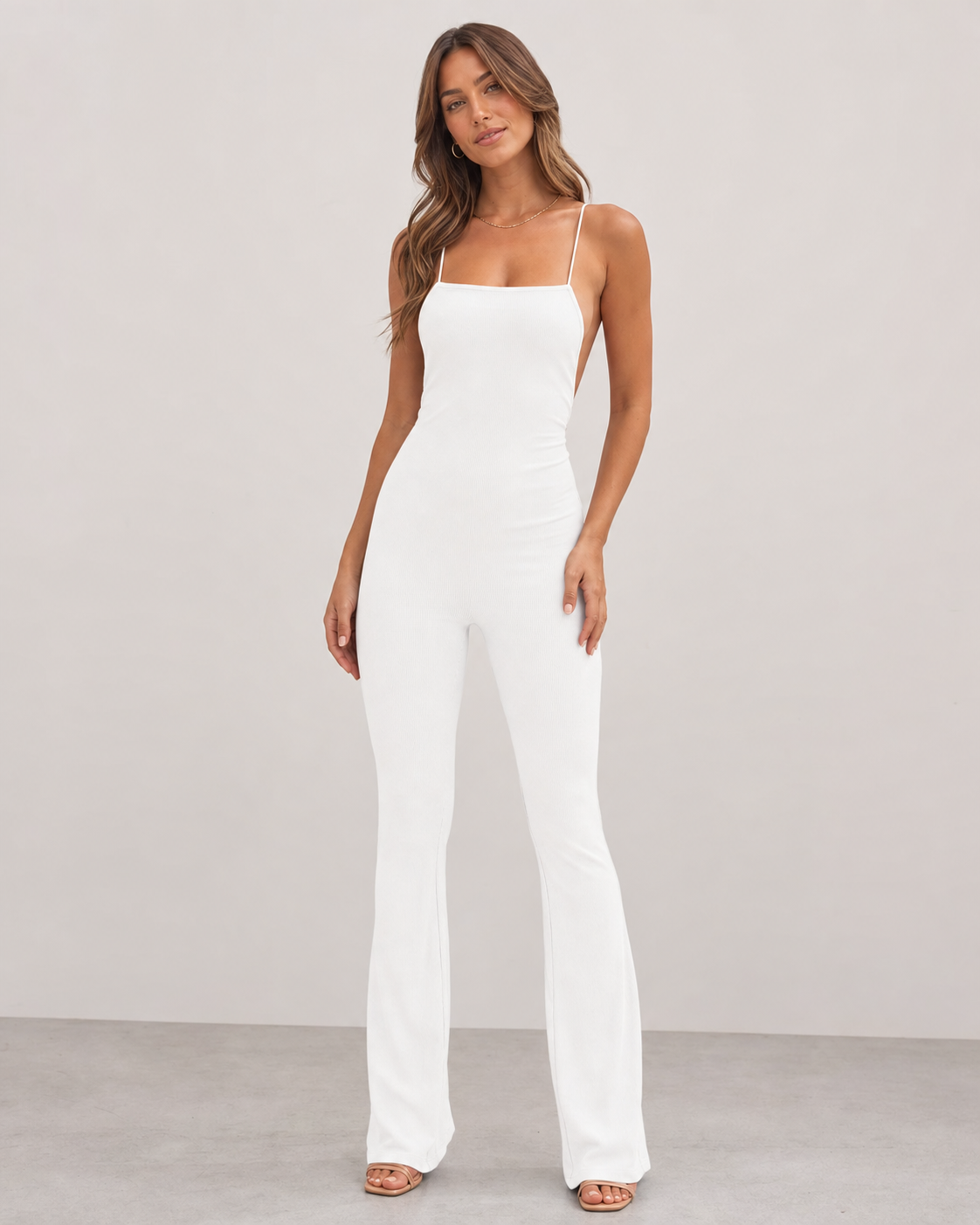 Different model wearing white sleeveless jumpsuit