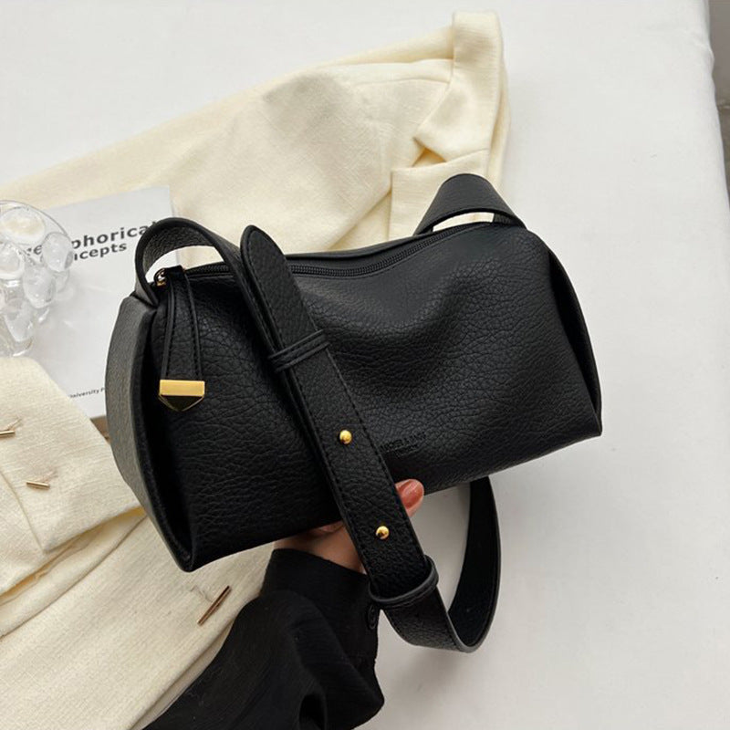 Black pillow shoulder bag showing zipper and strap details