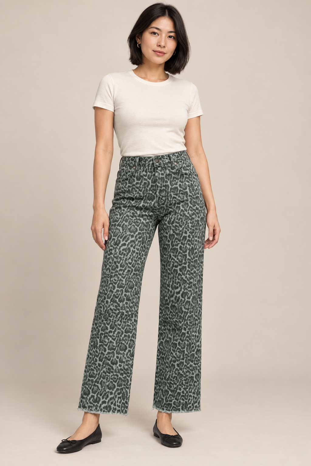 Woman wearing Gray1 frayed-hem wide-leg jeans in a studio.