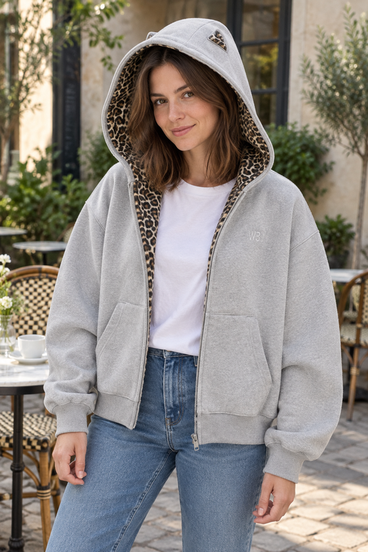 Women's gray cardigan jacket worn open, showing leopard detail inside the hood and front opening.