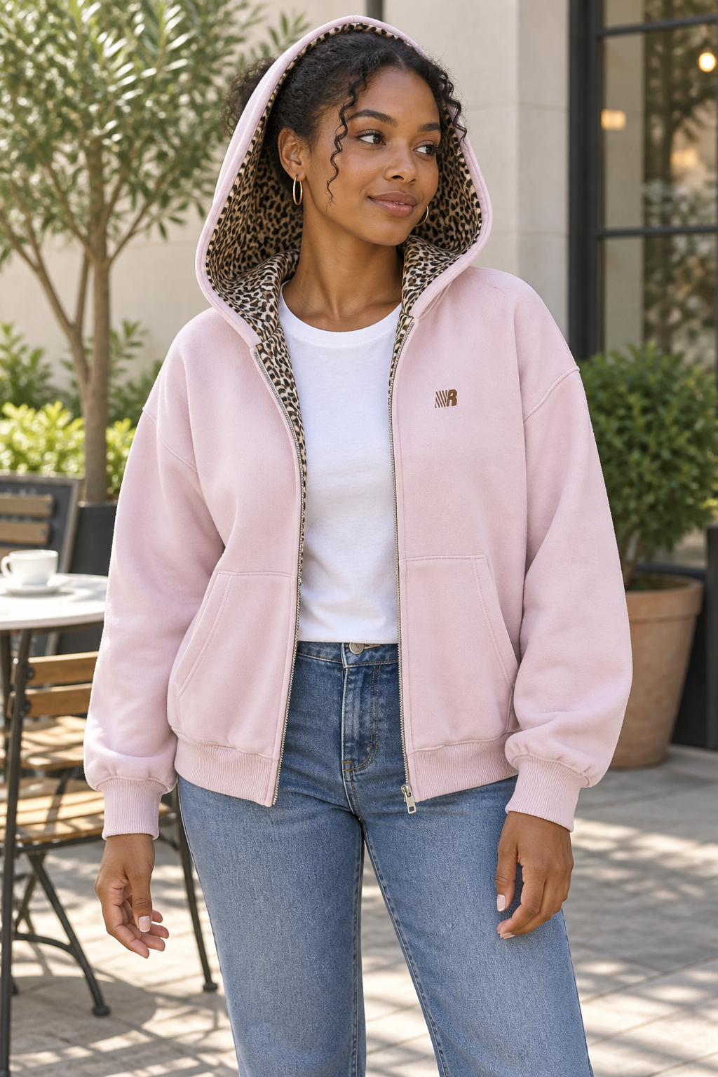 Women's pink cardigan jacket worn open, showing leopard detail inside the hood and front opening.
