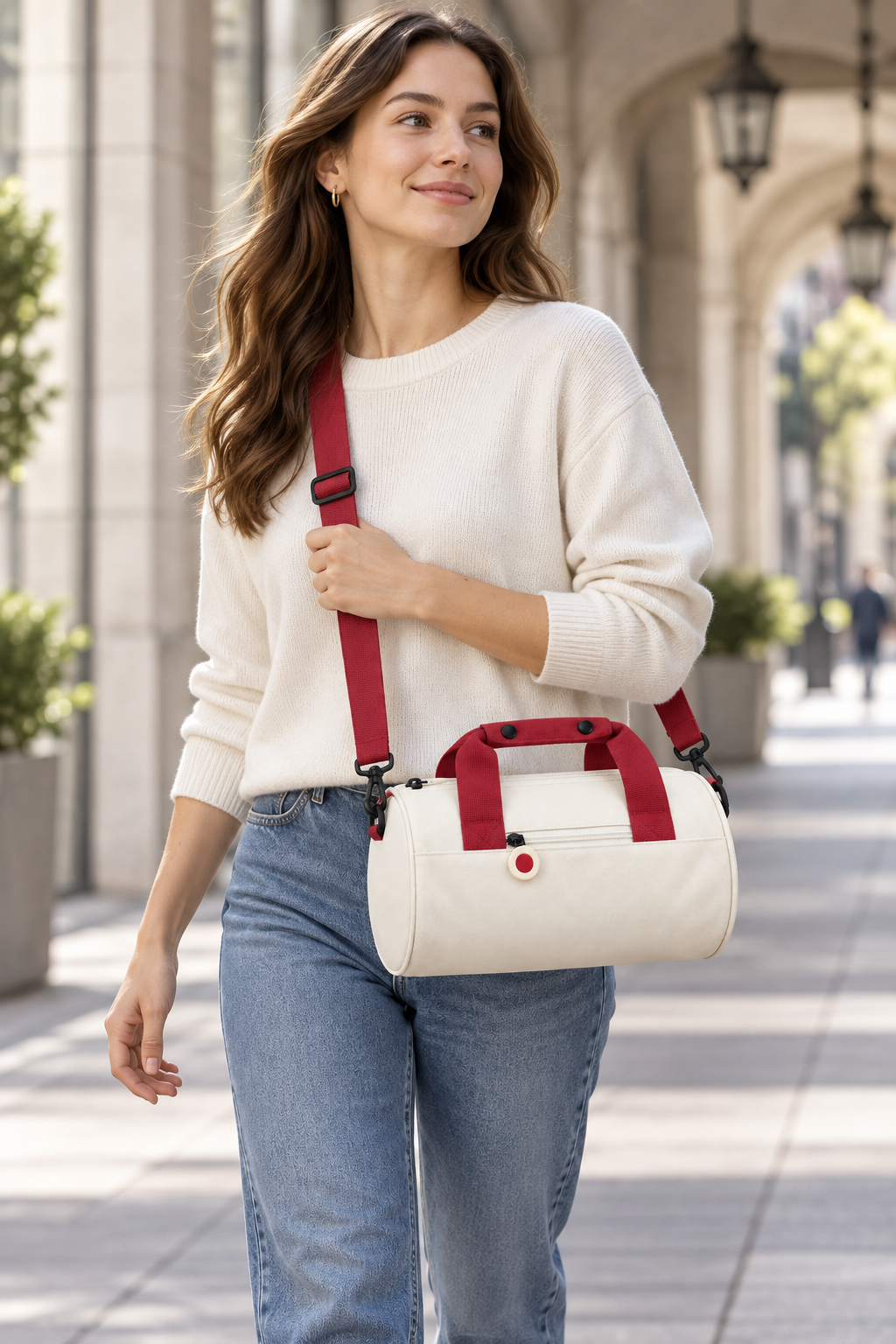 Woman carrying the Tea White and Brick Red Oxford travel shoulder bag by its shoulder strap