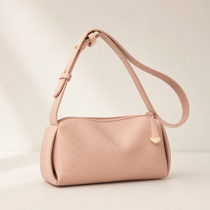 Pink AuraX pillow shoulder bag with adjustable strap on a neutral studio background