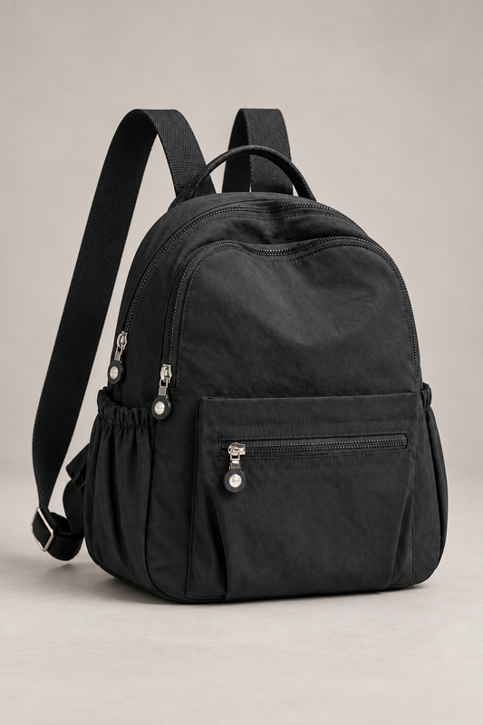 Women’s black compact nylon travel backpack studio view