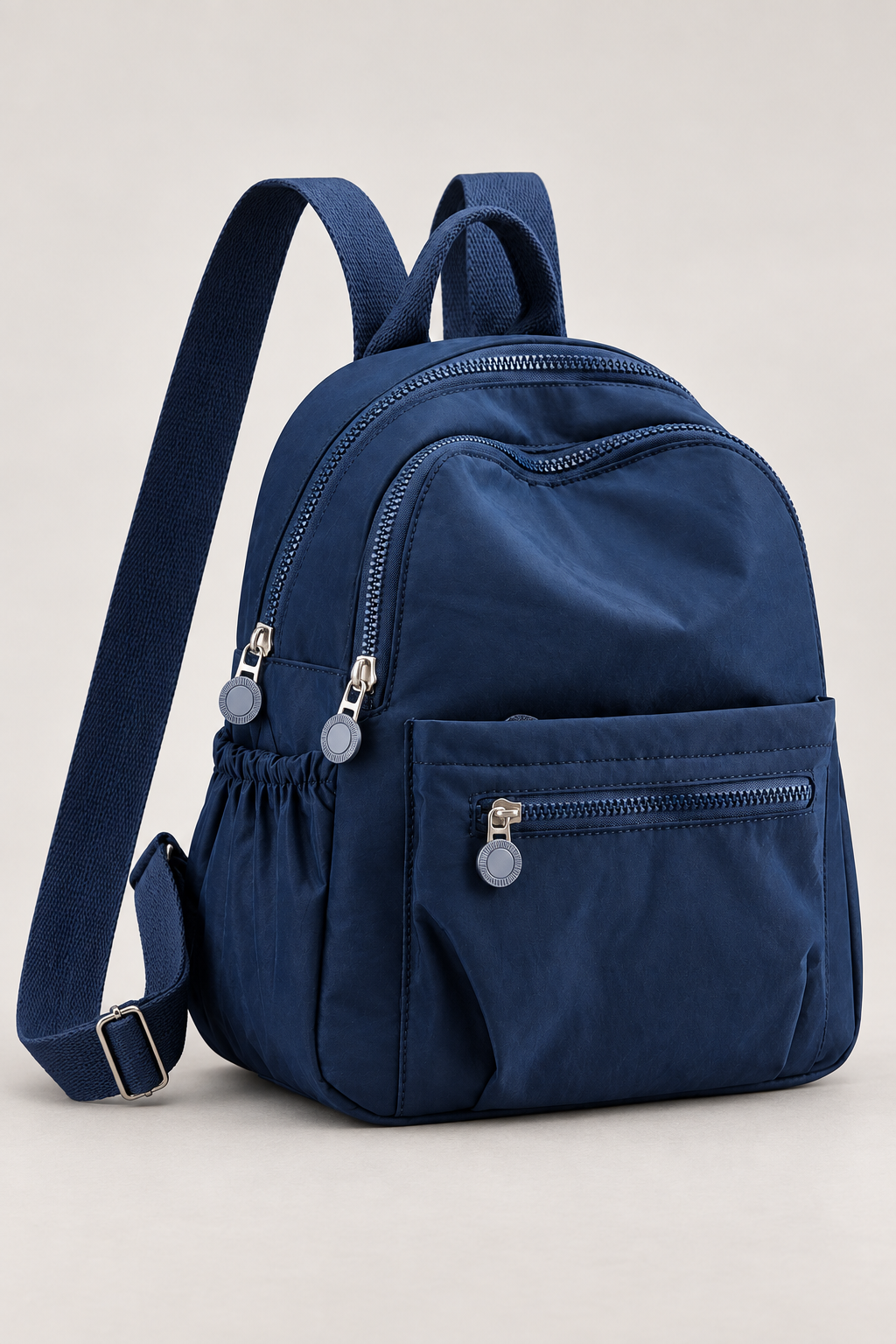 Women’s dark blue compact nylon travel backpack studio view
