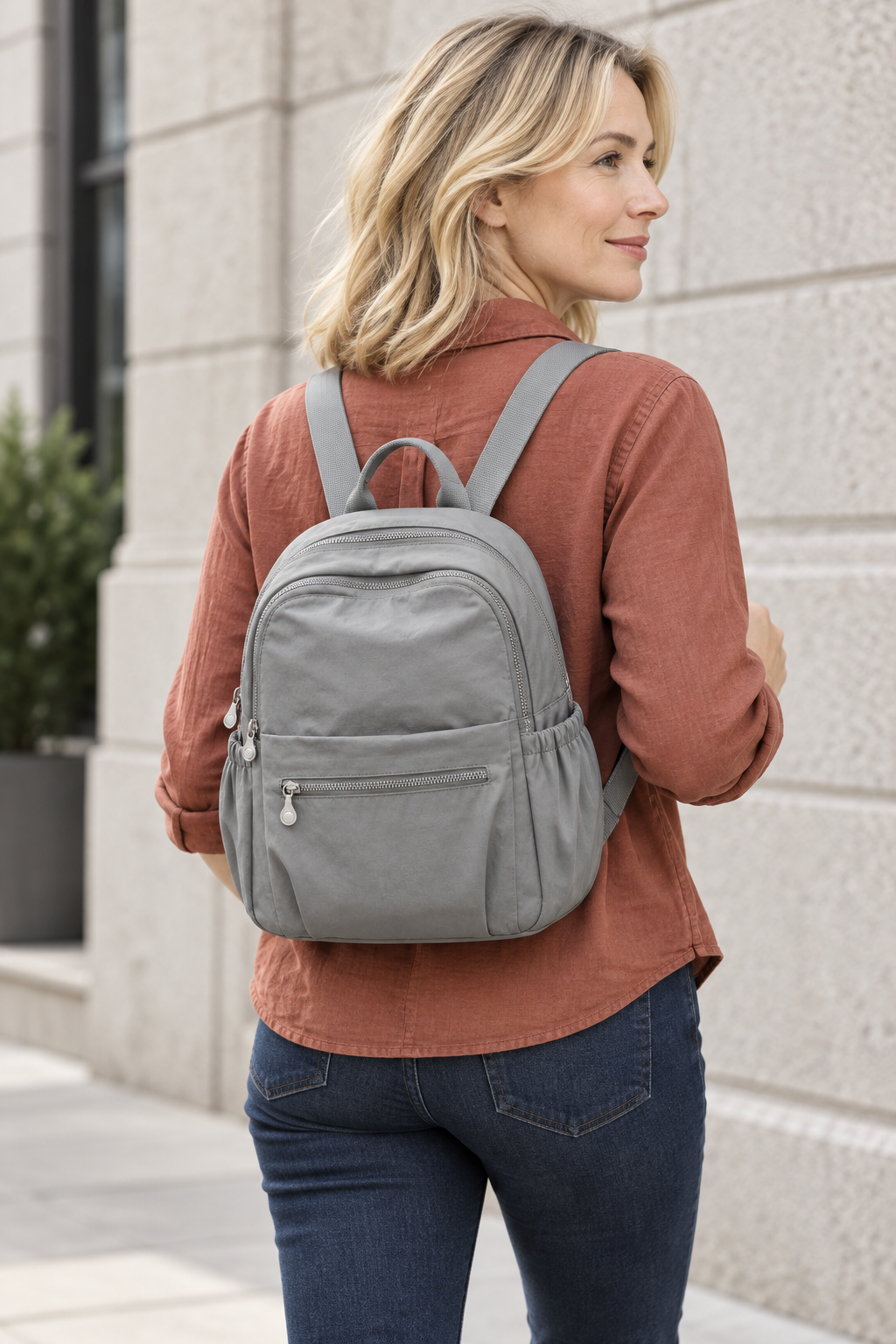 Women’s grey compact nylon travel backpack lifestyle view