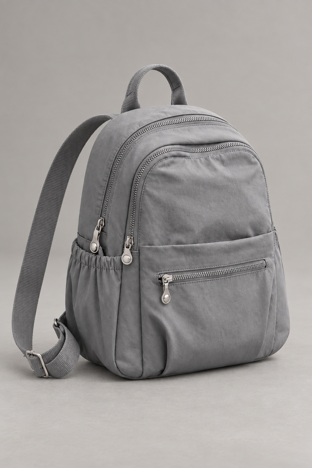 Women’s grey compact nylon travel backpack studio view
