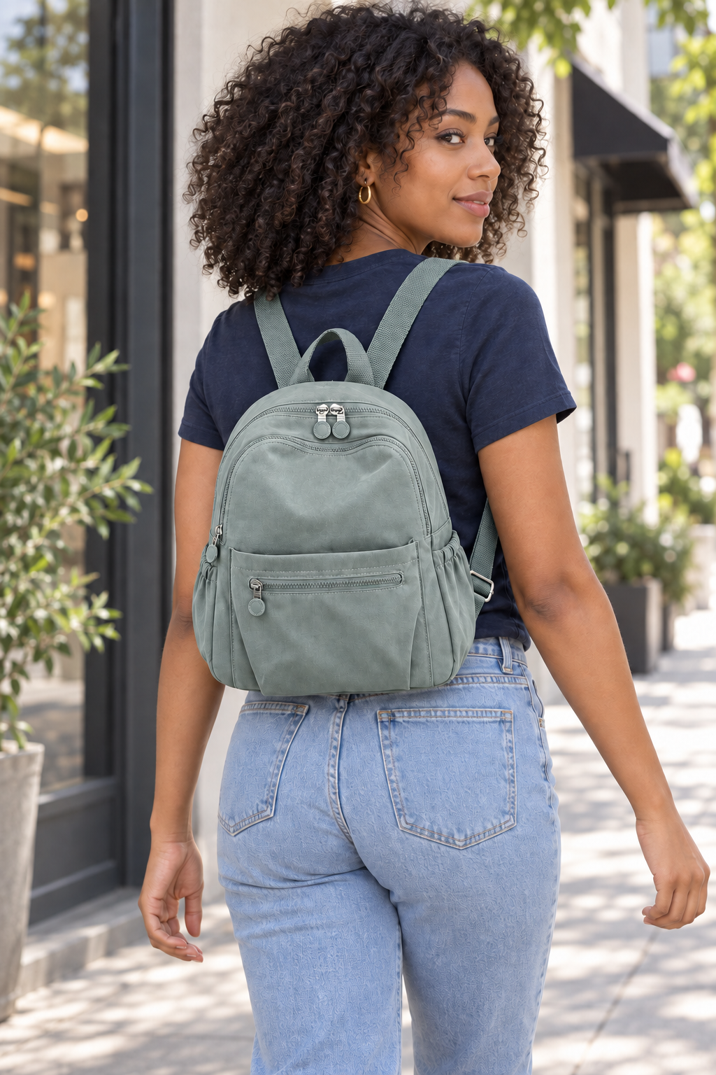 Women’s light green compact nylon travel backpack lifestyle view