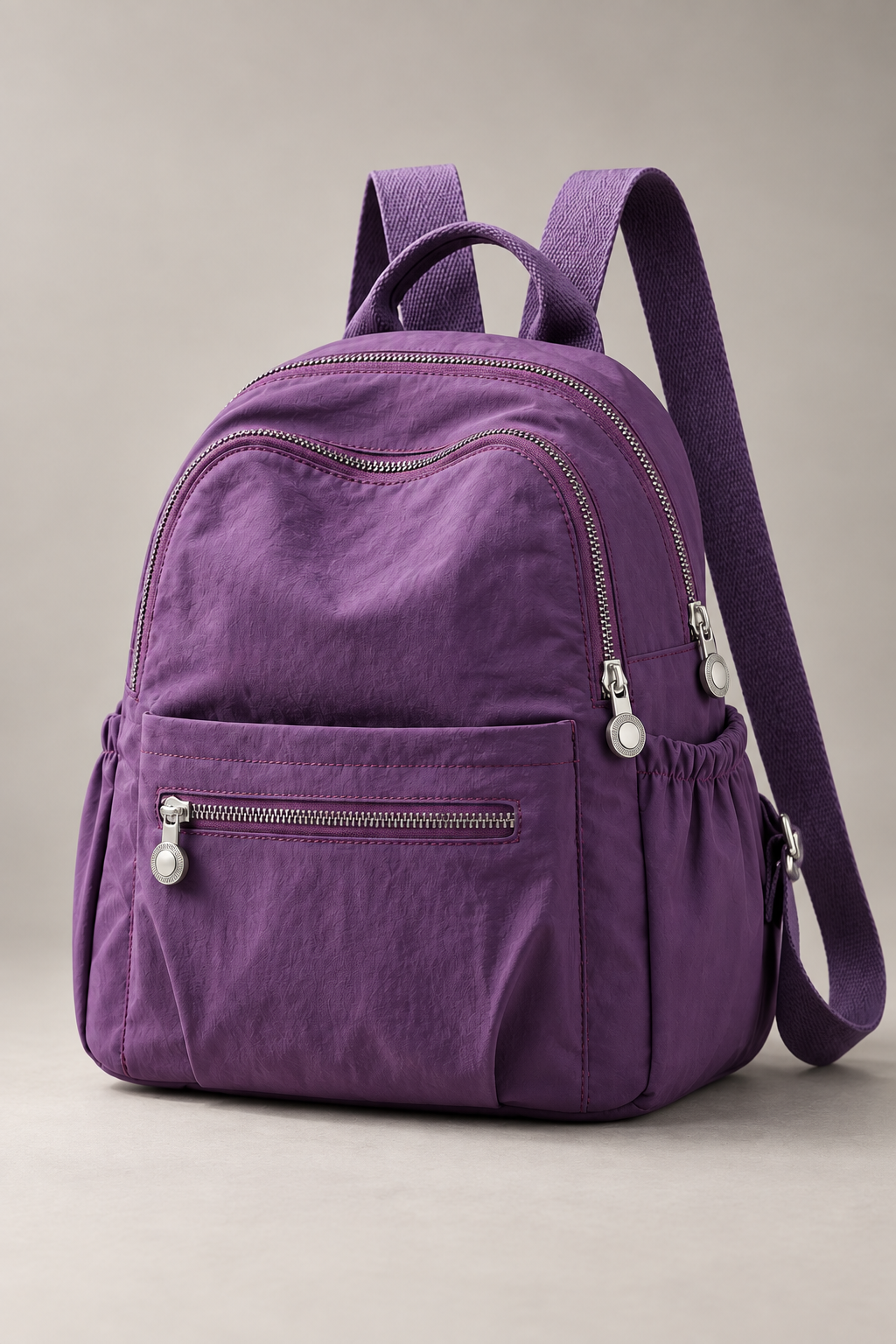 Women’s purple compact nylon travel backpack studio view