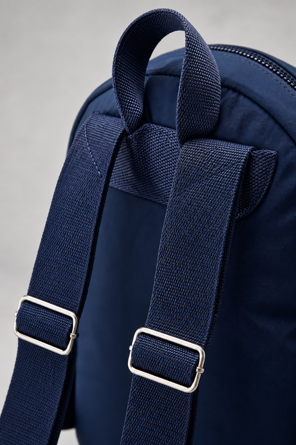Women’s dark blue compact nylon travel backpack back / strap construction