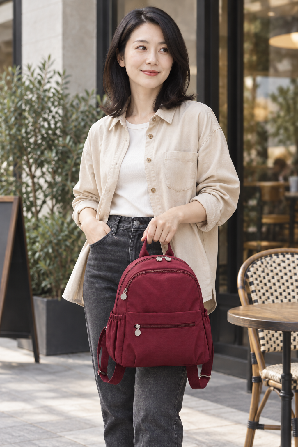 Women’s wine red compact nylon travel backpack lifestyle view