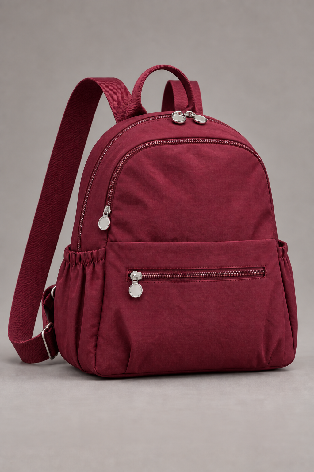 Women’s wine red compact nylon travel backpack studio view