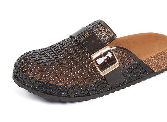 Close view of the Black mule’s translucent PVC lattice, cross-vamp strap, and gold-tone buckle