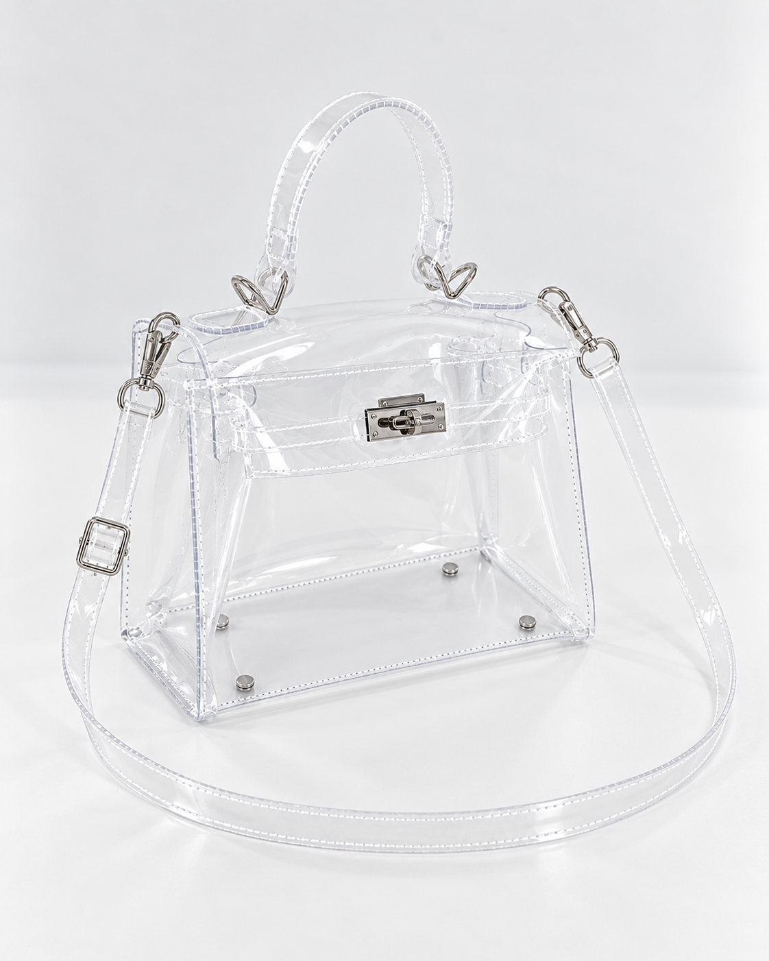 AuraX transparent PVC lock-buckle handbag with silver-tone hardware, three-quarter studio view