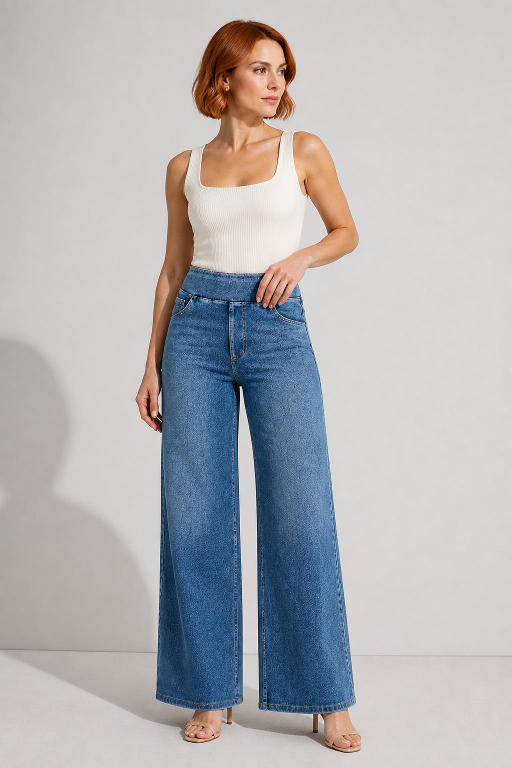 Model wearing AuraX high-waist wide-leg jeans in Medium Blue Distressed Wash
