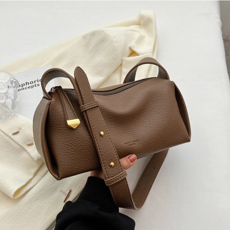 Brown pillow shoulder bag showing pebbled texture and hardware