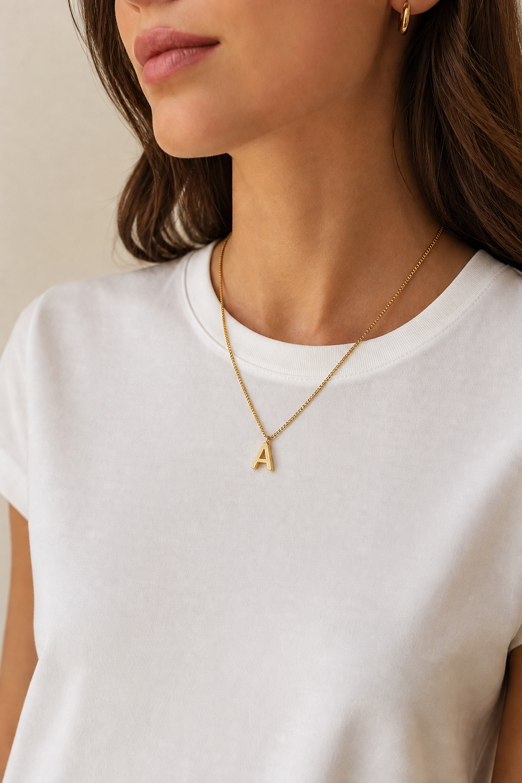 Model wearing gold initial A pendant necklace lifestyle photo