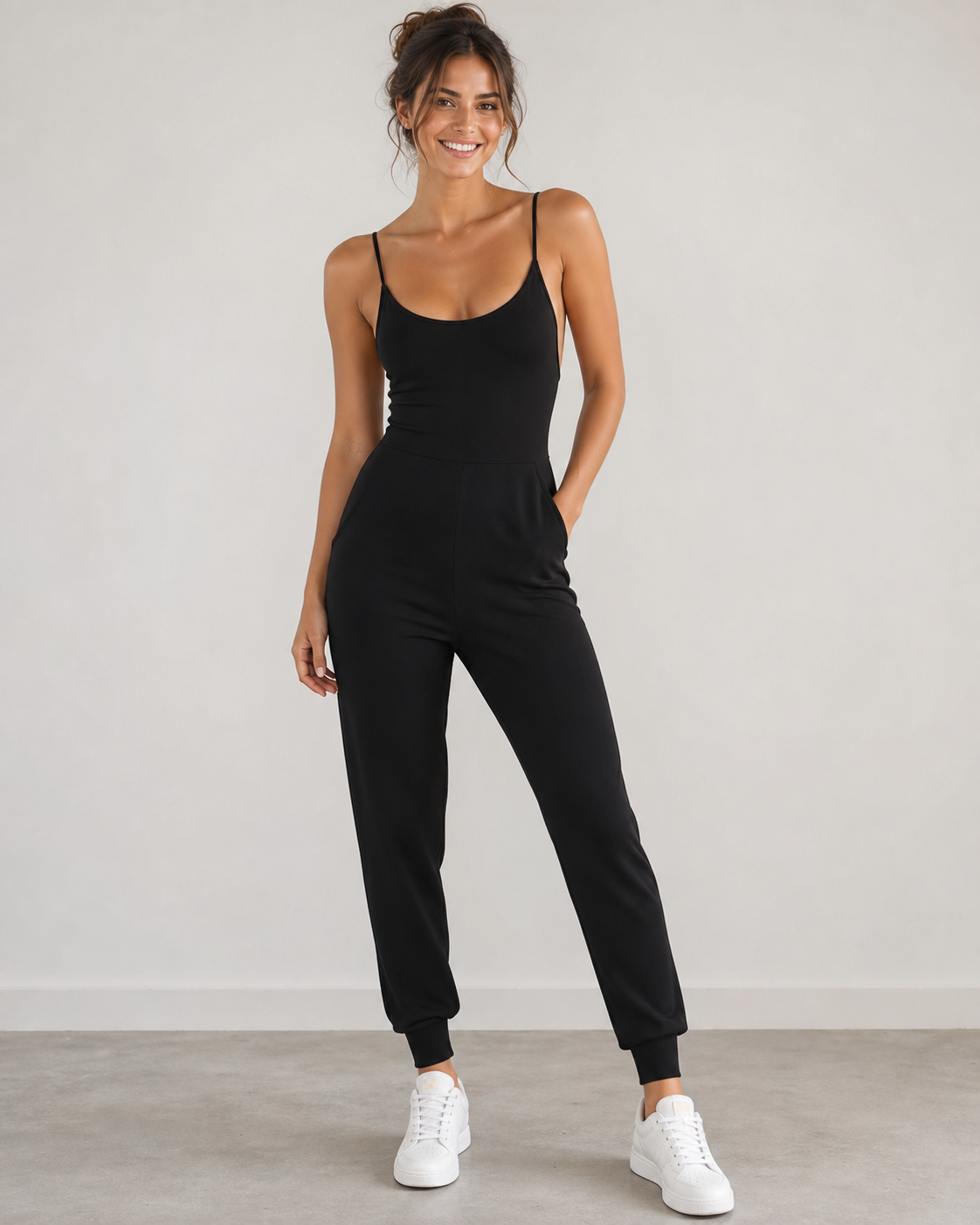 Model wearing black sleeveless jumpsuit